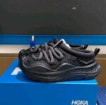 All-black athletic shoes with cushioned midsole