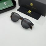 Black tiger pattern sunglasses with bold frame and dark tinted lenses