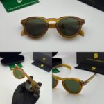 Brown frame sunglasses with green tinted lenses