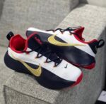 Nike white navy gold basketball shoes on feet