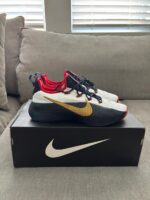 Nike white navy gold basketball shoes side view