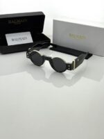 Side profile of gold and black optical glasses frame
