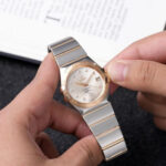 Elegant Omega Constellation Co-Axial Chronometer watch featuring diamond hour markers, two tone stainless steel bracelet, and premium luxury design.