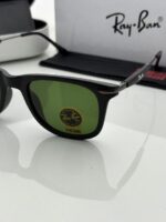 Black frame sunglasses with green tinted lenses