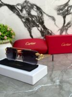 Gold and black frame sunglasses with black gradient lenses