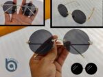Black round frame sunglasses with dark tinted lenses