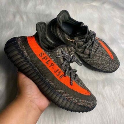 Grey knit sneakers with bright orange side stripe design