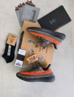 Cushioned sole grey orange running sneakers close view