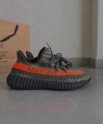 Modern grey knit sport shoes with orange stripe