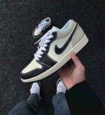 Coconut milk black low top leather sneakers side view