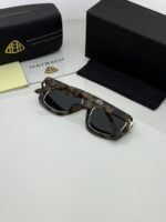 Modern military sunglasses on white background