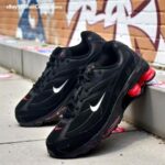 Lightweight black training sneakers with red accents