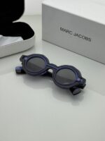 Chic eyewear with unique attachment detail.