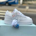 Clean white low top rubber sole sneakers